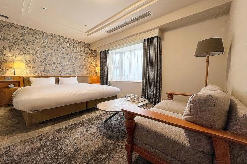 a hotel room with a bed and a couch at Richmond Hotel Tokyo Mejiro in Tokyo