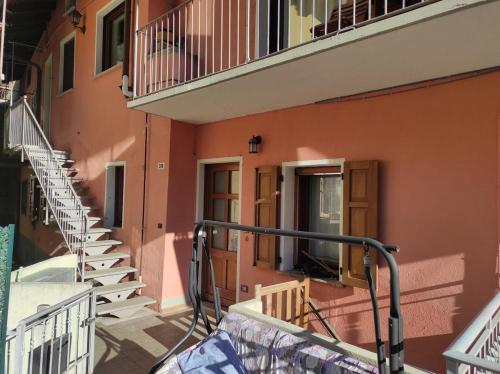 an orange building with stairs and a balcony at Le petit coin de Jason - Issogne in Issogne
