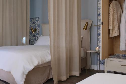 a bedroom with a bed with curtains in it at Casa Fellin 1891 B&B in Cles