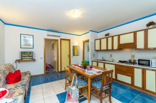 uma cozinha e sala de estar com mesa e cadeiras em Residence Miriam 2 em Bibione