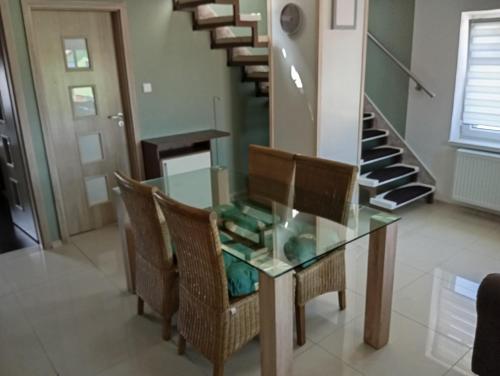 a dining room with a glass table and chairs at Apartmán Domažlice in Domažlice