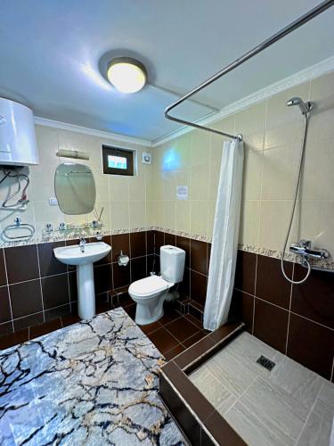 a bathroom with a sink and a toilet and a shower at Sky Village, Chimgan in Chimgan