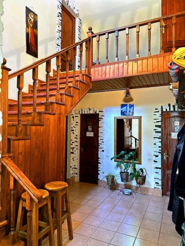 a wooden staircase in a living room with stools at Sky Village, Chimgan in Chimgan