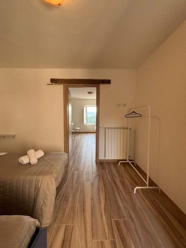 a bedroom with a bed and a wooden floor at La Casetta Sottosopra in Montefranco