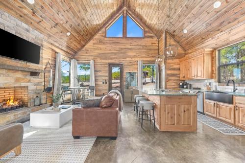 a kitchen and living room in a log cabin at NEW Woodland Escape with Spa & Fire pit - Sleeps 4 in Mount Herman