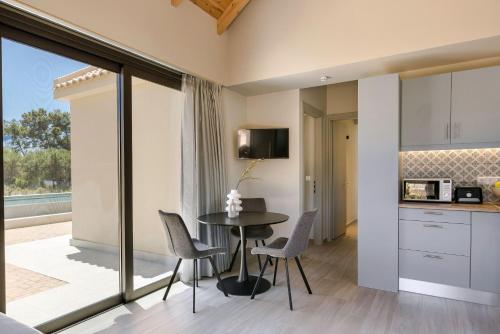 a kitchen and dining room with a table and chairs at SOUND OF SEA Villas in Lixouri