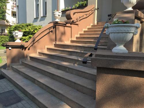 a set of stairs with vases on the side of a building at Apartamenty Vincent Sopot in Sopot