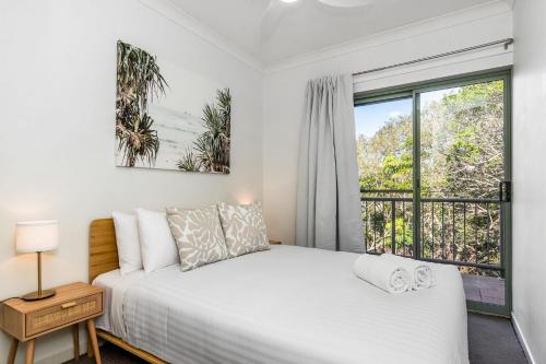 a bedroom with a bed and a window at Byron Beachside 2 in Byron Bay