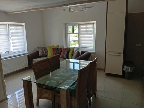 a living room with a glass table and a couch at Apartmán Domažlice in Domažlice