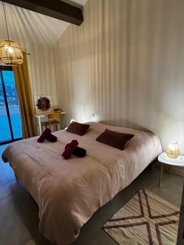 a bedroom with a large bed with red pillows on it at Chambre individuelle APT in Apt