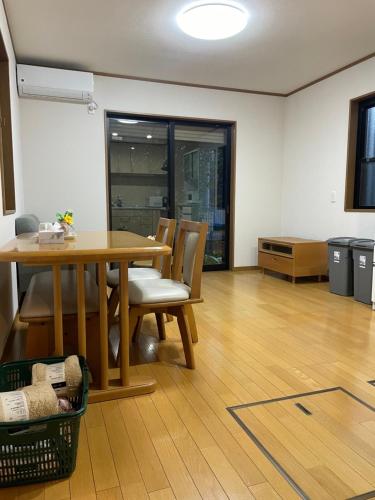 a dining room with a wooden table and chairs at 癒し家 in Tokyo