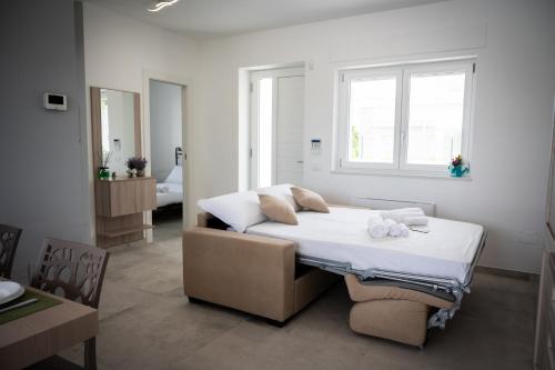 a bedroom with a bed in a room with a window at Likehome Ponente Levante 2 Ville luxury Pool 12pxs in Taranto