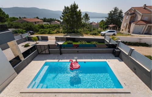 a swimming pool with a toy in the middle of a house at Lovely Home In Pridraga in Pridraga