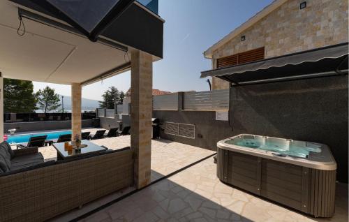 a patio with a hot tub and a swimming pool at Lovely Home In Pridraga in Pridraga