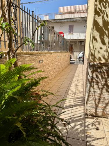 a walkway with a fence on the side of a building at Piccolo Brasile Home in Capaci