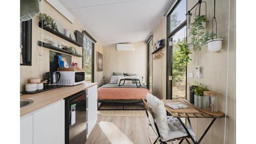 a tiny house with a kitchen and a living room at Delightfully Tiny by Tiny Away in Springmount