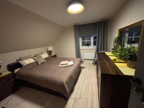 a bedroom with a large bed with a wooden floor at Manni Homestay in Kuressaare
