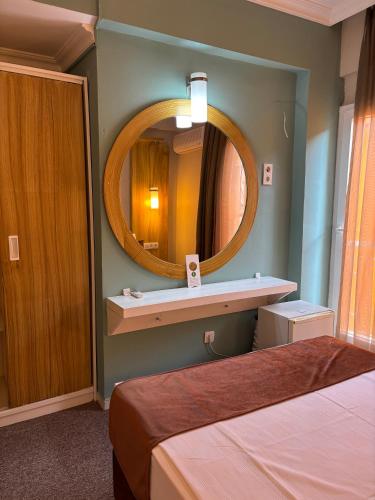 a room with two beds and a mirror at MOY Beldibi Hotel in Antalya