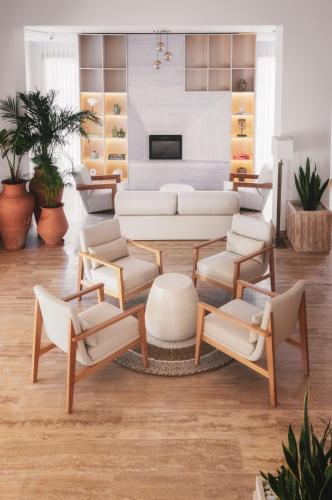 a living room with a white couch and chairs at Ruins Luxury Resort - Adults Only in Yalıkavak