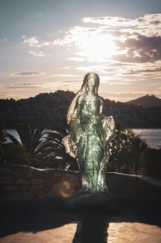 a statue of a woman sitting on a wall at Ruins Luxury Resort - Adults Only in Yalıkavak