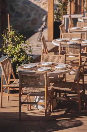 a wooden table and chairs sitting on a patio at Ruins Luxury Resort - Adults Only in Yalıkavak