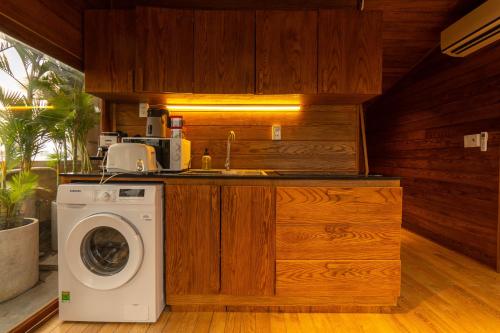 a kitchen with a washing machine and a sink at Nexus House Lang Bao Chi in Ho Chi Minh City