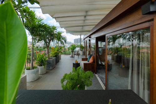 a balcony of a building with trees and plants at Nexus House Lang Bao Chi in Ho Chi Minh City