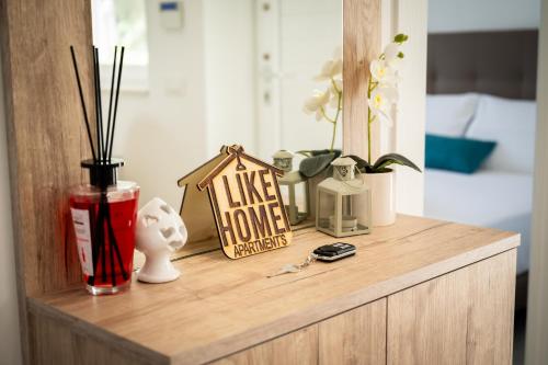 a wooden dresser with a house sign on it at Likehome Ponente Levante 2 Ville luxury Pool 12pxs in Taranto