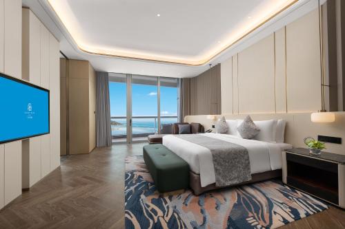 Ένα ή περισσότερα κρεβάτια σε δωμάτιο στο Hainan Sangem Moon Hotel