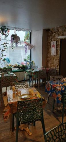 a dining room with a table and chairs and a room with tables and chairsktop at Hôtel Saint Florent in Orange