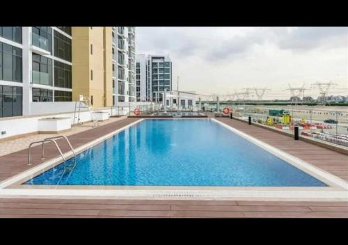 a large swimming pool on top of a building at Yogi - Studio in Azizi Riviera - MBR City & Pool in Dubai