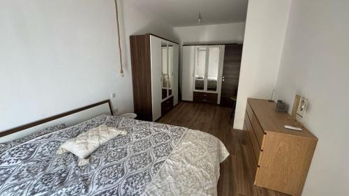 a bedroom with a bed and a dresser and a mirror at Cozy loft-duplex penthouse in Il-Gżira