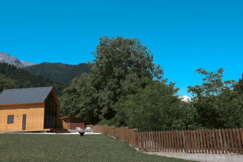 a wooden fence in front of a wooden house at OXYGEN utsera in Utsera