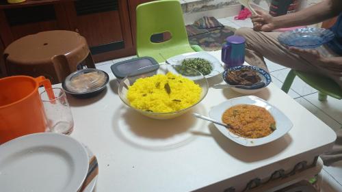 a table with many bowls of food on it at Family Home in Sharjah