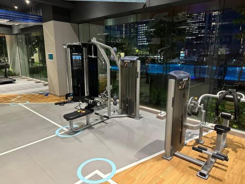 a gym with cardio equipment and a view of the city at KL Central 32 Floor KLCC View in Kuala Lumpur