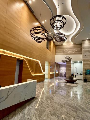 a lobby with a slide in the middle of a building at KL Central 32 Floor KLCC View in Kuala Lumpur
