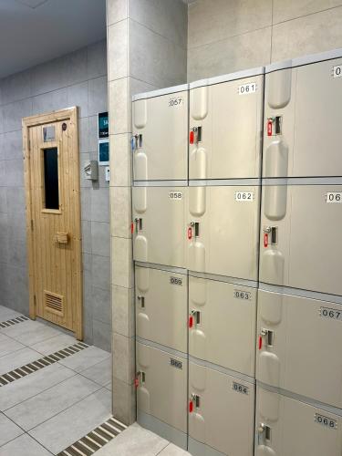 a row of lockers in a room with a door at KL Central 32 Floor KLCC View in Kuala Lumpur