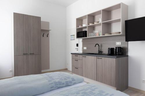 a small kitchen with a bed and a sink at Haus Viasana in Bad Ischl