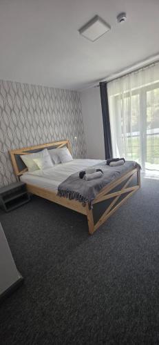 a large bed in a room with a large window at Panorama Budești in Budeşti