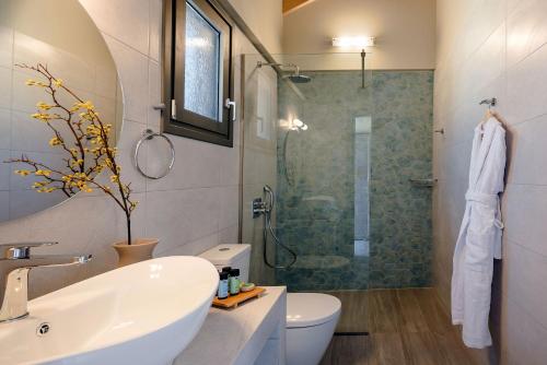 a bathroom with a sink toilet and a shower at SOUND OF SEA Villas in Lixouri