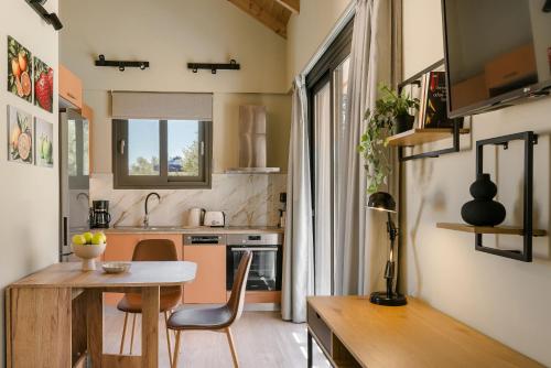 a small kitchen with a table and chairs in a room at SOUND OF SEA Villas in Lixouri