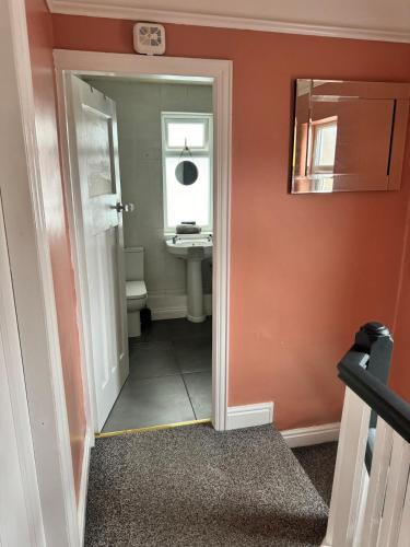 a bathroom with a sink and a mirror at Beautiful three bedroom house in Liverpool