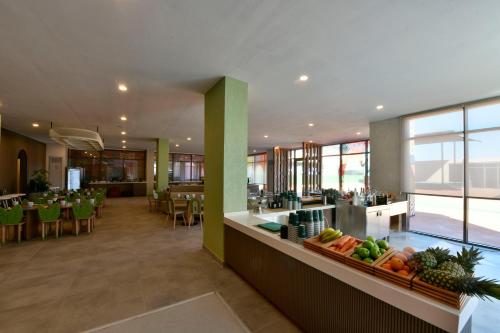 a kitchen and dining room with fruits and vegetables on a counter at Ethno Belek in Belek