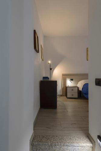 a bedroom with a bed and a dresser in a room at appartamenti i fiori del lago in Laveno
