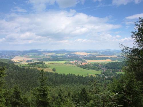 a view of a green valley with trees and buildings at Apartmán Hortenzie in Mařenice