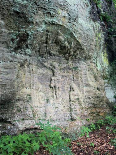 a rock wall with a carving of people on it at Apartmán Hortenzie in Mařenice