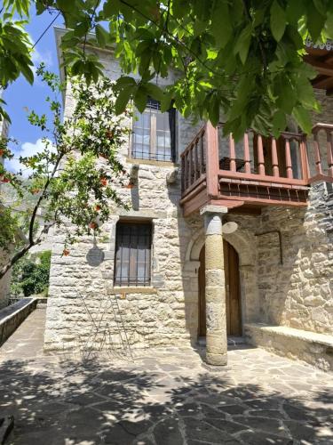 a building with a balcony on the side of it at The Mountain House -mountain getaway in Sirako
