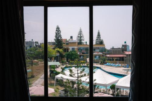 a view of a swimming pool from a window at Club Bagmati by HSH in Bhaktapur