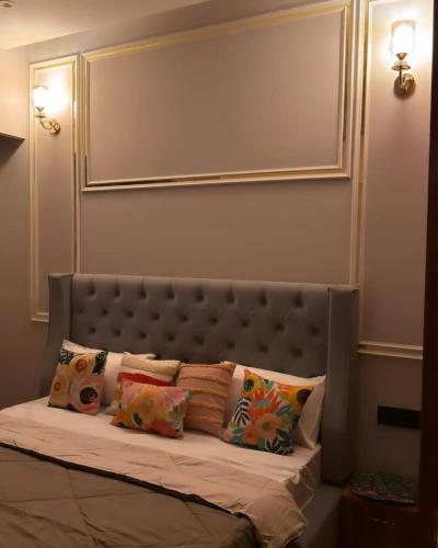 a bed with pillows on it in a room at square residency in Ghaziabad