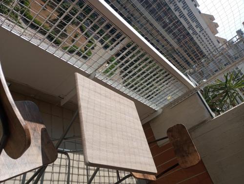 a balcony with two chairs and a solarium at Executive center rooms in Bari